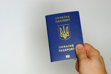 Blue Ukrainian passport in the hands of a man. Isolate