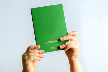 green  passport in the hands of the child. Isolate