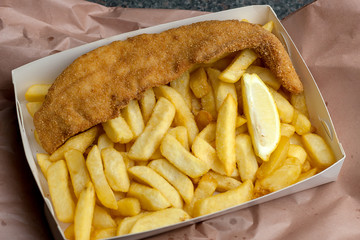 traditional Australian battered barramundi fish and chips in card box takeaway