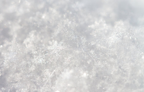 Accumulation of snowflakes in sharp detailed macro image shot showing frosty patter formal texture