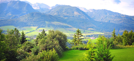 beautiful summer panorama of the mountain alps, landscape of green hills and meadows