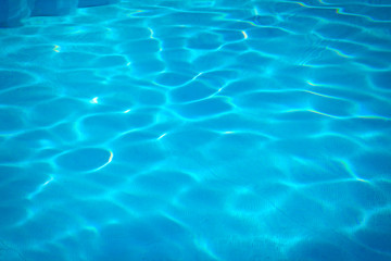 Fototapeta na wymiar texture of the blue water in the pool