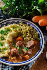 Traditional irish stew served with potatoes and cabbage