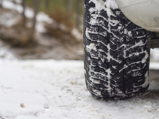 close-up car winter tires and snow