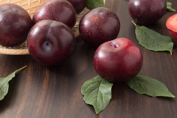 Plums on wooden background