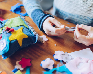 tailor art workshops for children - a girl sewing felt decorations - obrazy, fototapety, plakaty