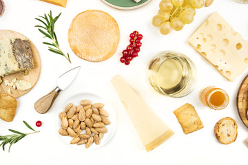 Various types of cheese with wine on a white background with copy space