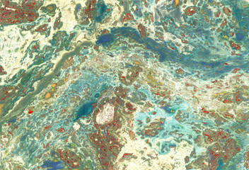 Multicolored marbled paper background in green, blue and earthy colors