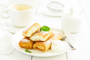 Russian crepes stuffed with curd and cherry.