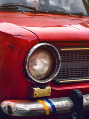 red, classic car worn out of the hood