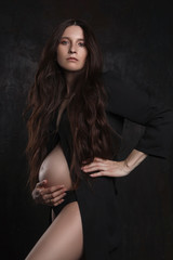 Obraz na płótnie Canvas stylish portrait of pregnant woman on dark background