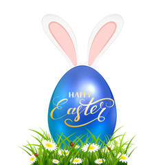 Blue Easter egg in grass with rabbit ears on white background