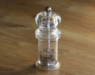 glass Pepper mill set on wooden background
