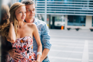 Fototapeta premium close up portrait of stylish couple in love on the street. Pretty man and gorgeous woman hugging.