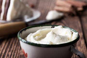 Homemade cream cheese frosting in rural mug
