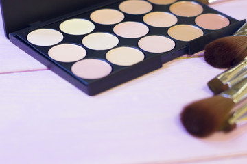 Cosmetic products on white wooden background