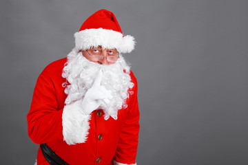 Real Santa Claus carrying big bag full of gifts, isolated on white background