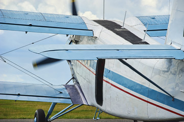 Close up view of a vintage propeller passenger and cargo airplane takes off.
