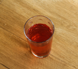 Glass with fresh Strawberry lemonade on wooden background