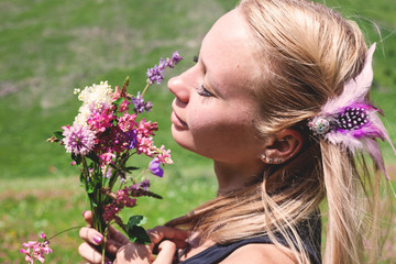 Young woman smells flowers