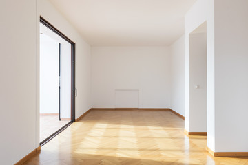 New room completely empty with wooden floors
