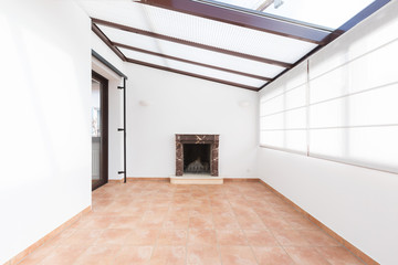 Unfurnished room with large windows on the ceiling and fireplace