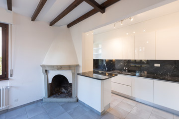 Kitchen in open space near living room with fireplace