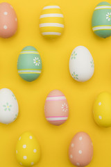 Painted easter eggs on a bright yellow background