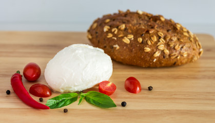 Mozzarella cheese with cherry tomatoes, basil and cereal bread