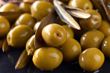 Green olives with leaves.