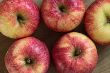 Fresh red and yellow royal gala apples on wooden background