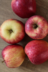 Fresh red and yellow royal gala apples on wooden background