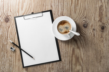 Blank letterhead, clipboard, pencil, sharpener and coffee cup on wooden background. Responsive design template.
