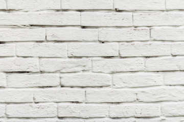 Front view of brick wall painted in white
