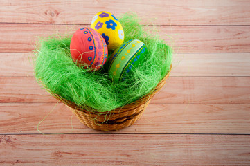 Easter painted eggs laying in basket on table