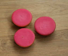 mini pink fondant cakes on wooden background