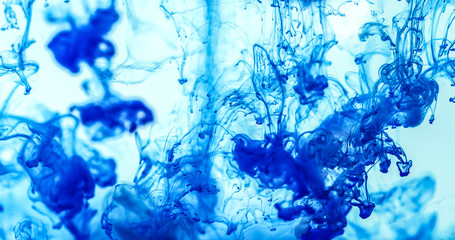 Close up a blue colored drop in the water , abstract motion movement of watercolor ink splashing as frame border background
