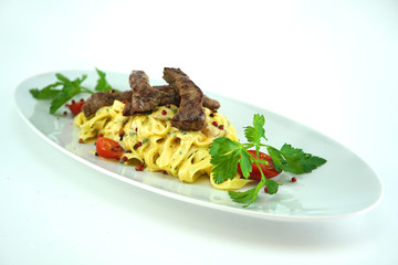grilled pork meat with pasta