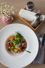 salad with vegetables and mushrooms on a white plate. concept: vegetarianism healthy eating