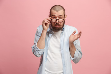 Beautiful bored man bored isolated on pink background