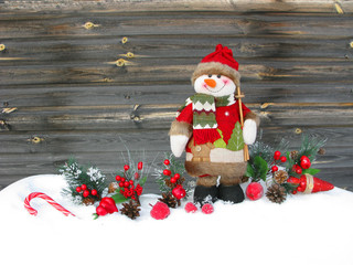 christmas snowman decoration winter berries and snow on wooden background