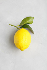 large ripe yellow lemon with leaves. traditional italian fruit Sicilian lemon on a light background top view.