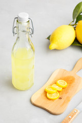 limoncello on a light background. summer traditional Italian drink of home-made liqueur from Sicilian lemons. Alcoholic drink is yellow. articles made of fruits.