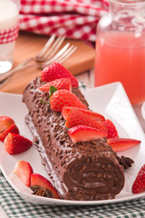 Chocolate roll with strawberries. 