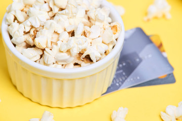 Fresh white popcorn. Yellow background. White plate