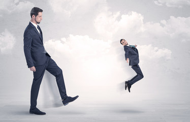 Fototapeta premium Big boss kicking little employee