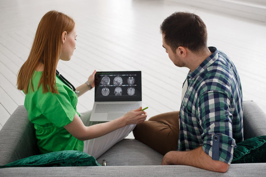 Female doctor and male patient looking at MRI concept healthcare, medical and radiology concept