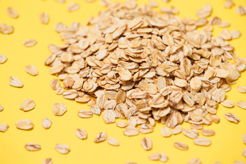 Muesli for breakfast. Healthy food. Yellow bright background. Many flakes