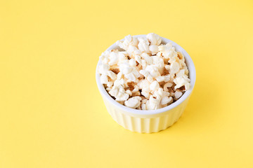 Yellow bright background. White Pop Corn. Fried corn