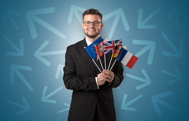 Cheerful boy standing with flag and arrows around